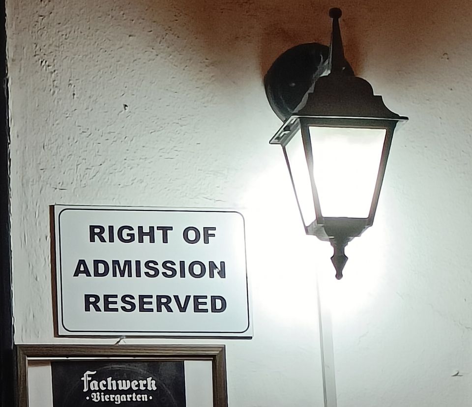 A "Right of Admission Reserved" sign at the entrance of a restaurant — a common measure in Namibia to keep unwanted people out
